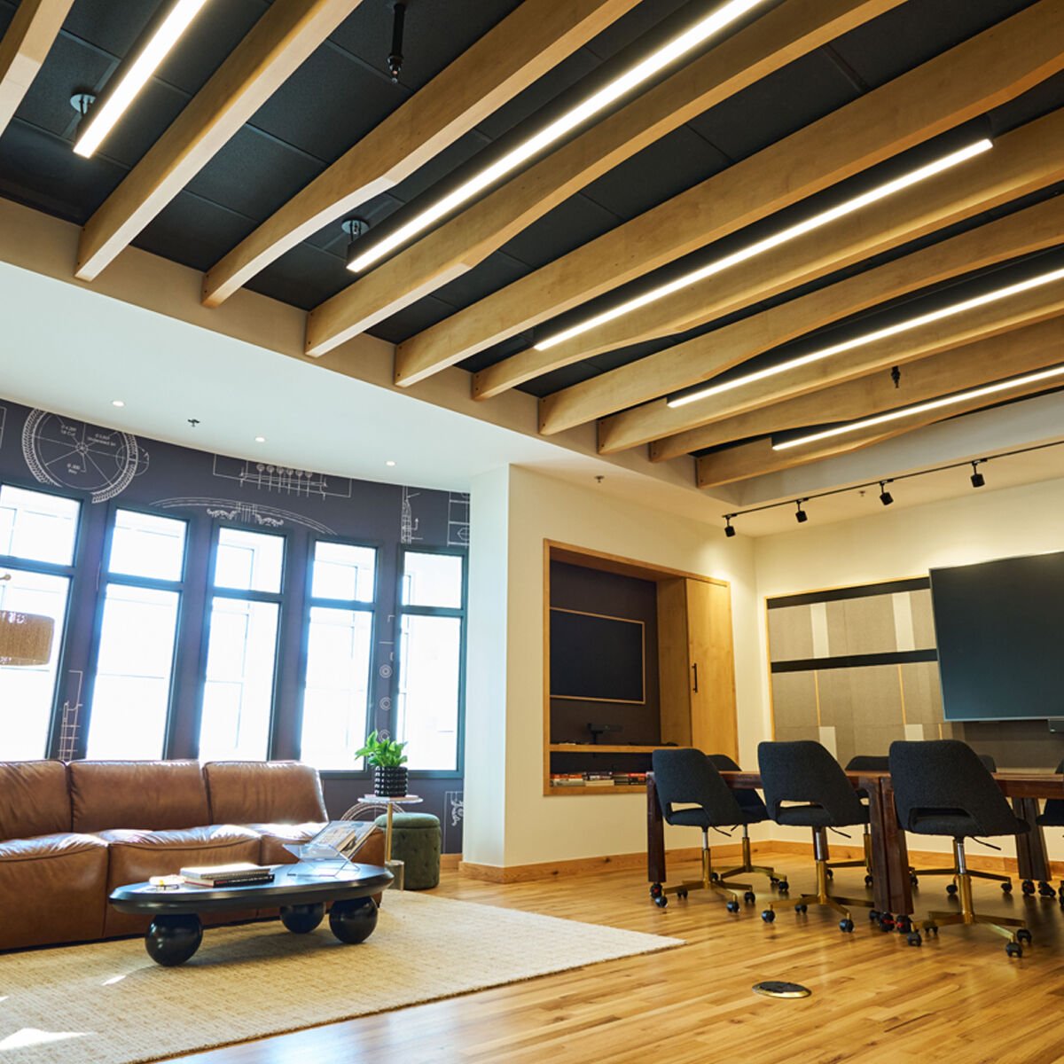 Photo of a room interior with wood beams on the ceilings and big windows